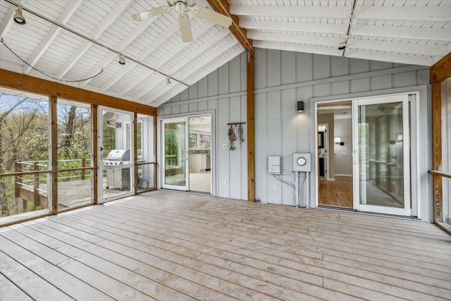 unfurnished sunroom featuring lofted ceiling, ceiling fan, and track lighting