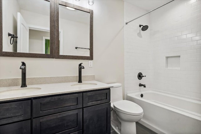 bathroom with toilet, bathtub / shower combination, and double vanity