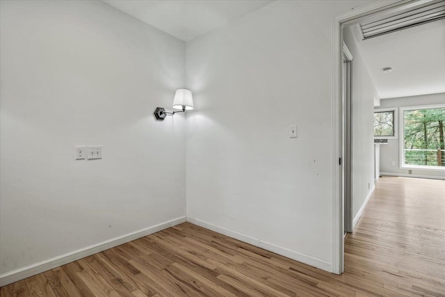 empty room with wood finished floors and baseboards