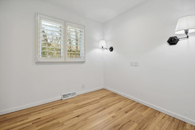 unfurnished room featuring wood finished floors and baseboards