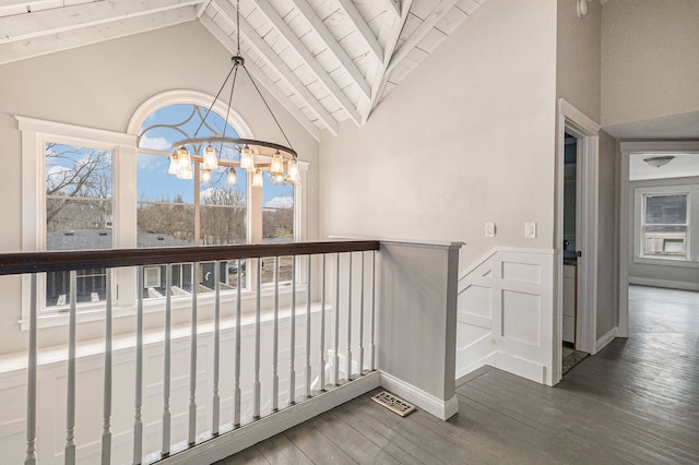 4985 Lockhart St, West Bloomfield, MI 48323 - corridor featuring a chandelier, healthy amount of natural light, high vaulted ceiling, wood finished floors, and wainscoting