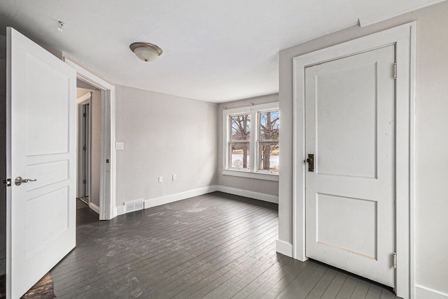 4985 Lockhart St, West Bloomfield, MI 48323 - spare room featuring baseboards and dark wood-style flooring