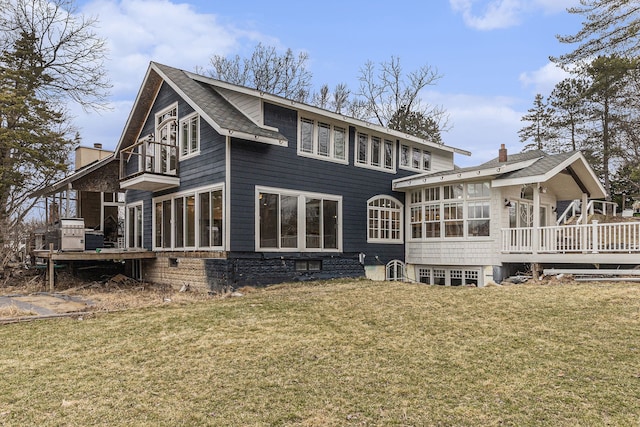 4985 Lockhart St, West Bloomfield, MI 48323 - rear view of property featuring a sunroom, a deck, a chimney, and a yard