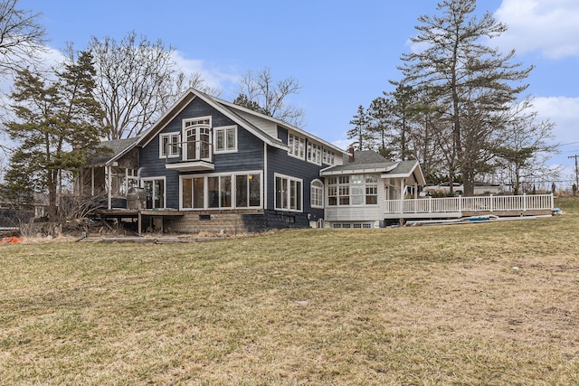 4985 Lockhart St, West Bloomfield, MI 48323 - rear view of property with a sunroom, a deck, and a lawn