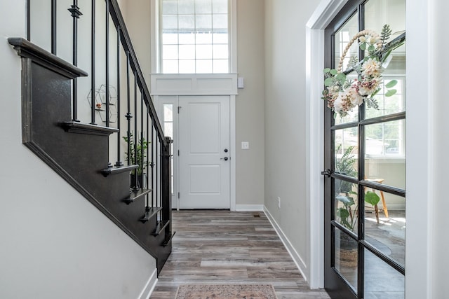 18767 Millar Rd, Clinton Township, MI 48036 - entryway featuring wood finished floors, stairway, baseboards, and a towering ceiling