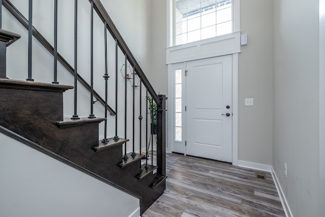 18767 Millar Rd, Clinton Township, MI 48036 - entryway with stairway, wood finished floors, a towering ceiling, and baseboards