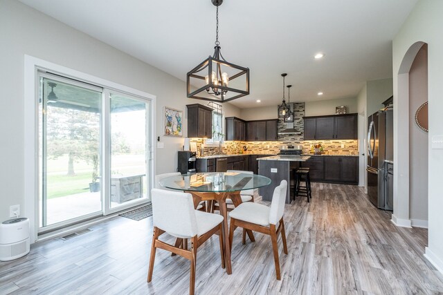 18767 Millar Rd, Clinton Township, MI 48036 - dining room featuring a chandelier, light wood-type flooring, and recessed lighting