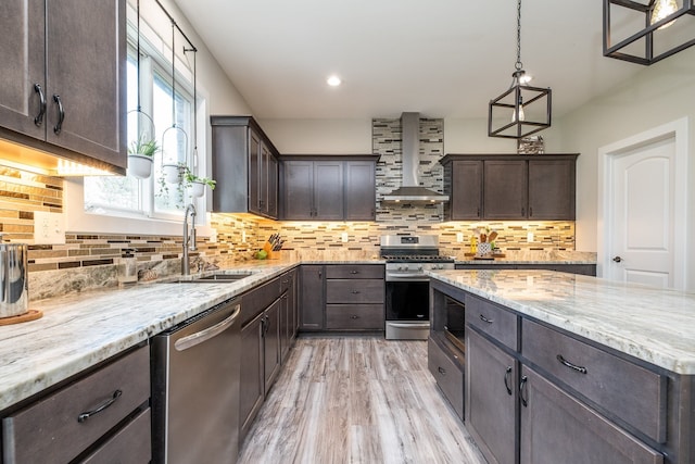 18767 Millar Rd, Clinton Township, MI 48036 - kitchen with stainless steel appliances, wall chimney range hood, dark brown cabinets, light stone countertops, and recessed lighting