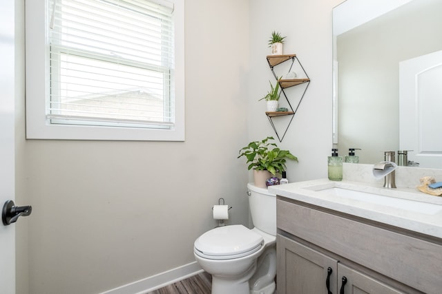 18767 Millar Rd, Clinton Township, MI 48036 - half bathroom with toilet, vanity, wood finished floors, and baseboards