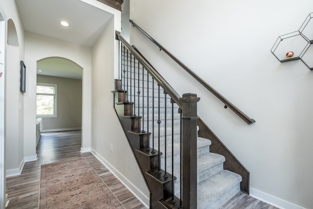 18767 Millar Rd, Clinton Township, MI 48036 - staircase with arched walkways, wood finished floors, baseboards, and recessed lighting