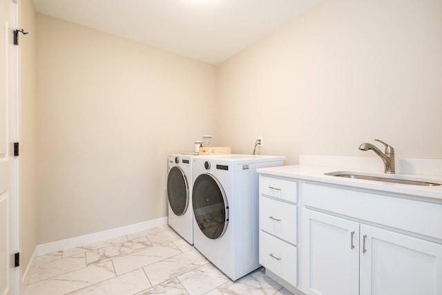 18767 Millar Rd, Clinton Township, MI 48036 - clothes washing area with washer and clothes dryer, light marble finish floors, baseboards, and cabinet space