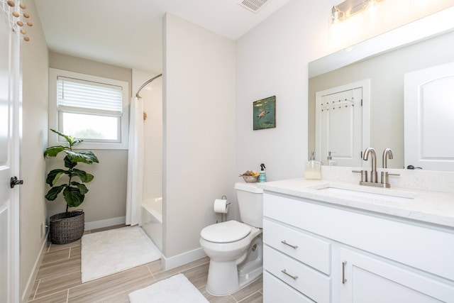 18767 Millar Rd, Clinton Township, MI 48036 - full bathroom featuring toilet, wood finished floors, vanity, baseboards, and shower / bath combo with shower curtain