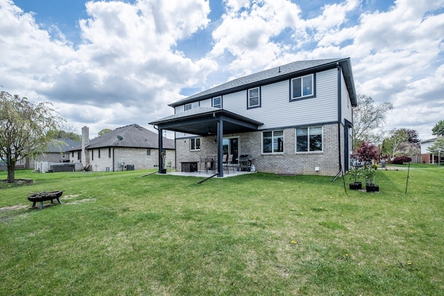 18767 Millar Rd, Clinton Township, MI 48036 - rear view of house with a patio, a lawn, and brick siding