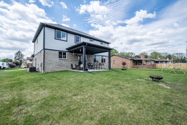 18767 Millar Rd, Clinton Township, MI 48036 - back of property featuring a patio, brick siding, a fire pit, and central AC