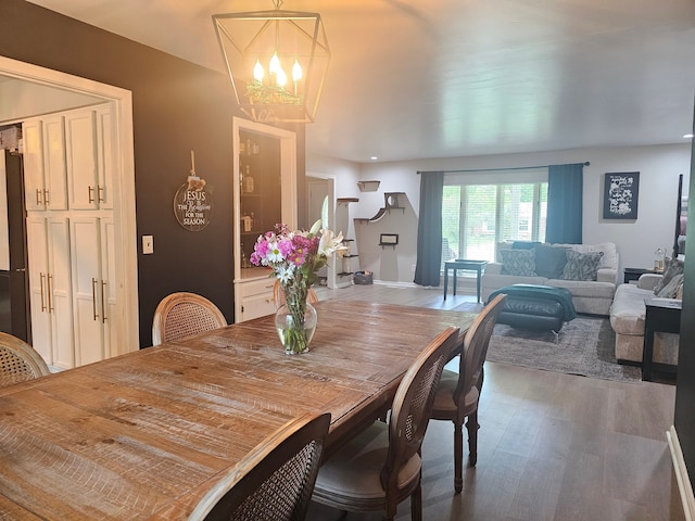 dining room featuring a chandelier, wood finished floors, and recessed lighting