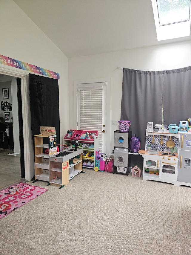rec room with carpet floors, a skylight, and lofted ceiling