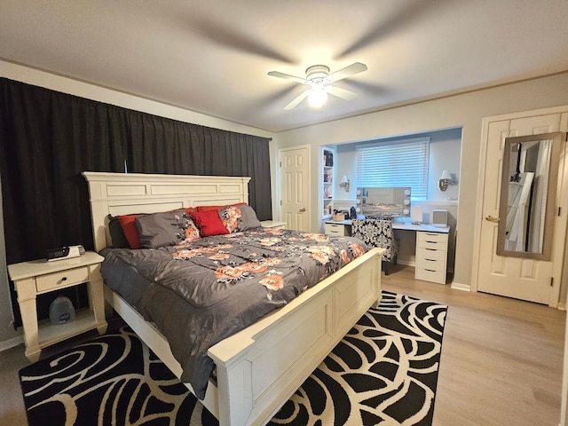 bedroom with light wood-type flooring and a ceiling fan