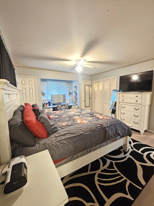 bedroom featuring light colored carpet and ceiling fan