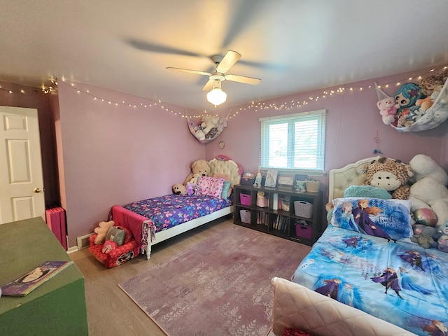 bedroom featuring wood finished floors and ceiling fan