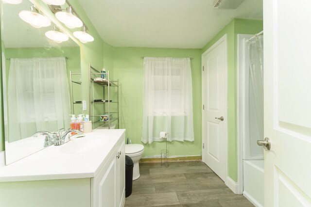 466 Wayland Ave, East Lansing, MI 48823 - full bath with wood finished floors, vanity, toilet, a shower with shower curtain, and baseboards
