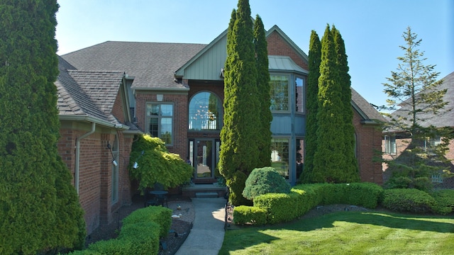 54545 Pelican Ln, Shelby Twp, MI 48315 - view of front facade with brick siding and a front yard