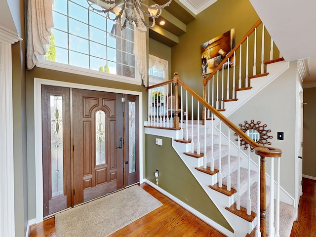 54545 Pelican Ln, Shelby Twp, MI 48315 - foyer entrance with wood finished floors, plenty of natural light, baseboards, a towering ceiling, and ornamental molding