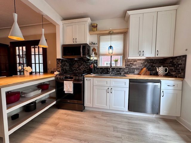 95 Mapleton Rd, Grosse Pointe Farms, MI 48236 - kitchen featuring stainless steel appliances, white cabinetry, and backsplash
