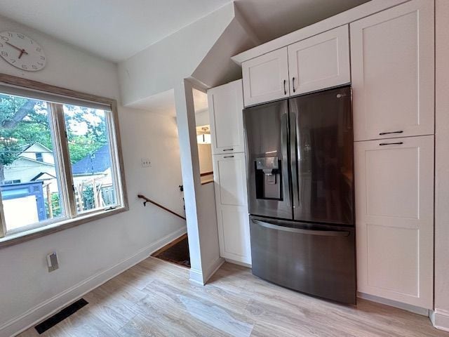 95 Mapleton Rd, Grosse Pointe Farms, MI 48236 - kitchen featuring black fridge, light wood finished floors, baseboards, and white cabinetry