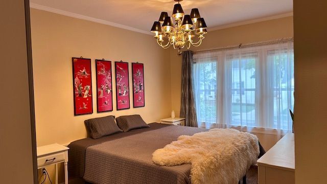 95 Mapleton Rd, Grosse Pointe Farms, MI 48236 - bedroom with a chandelier and crown molding