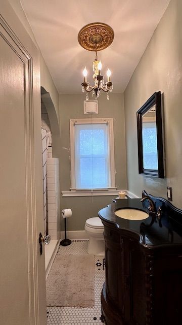 95 Mapleton Rd, Grosse Pointe Farms, MI 48236 - full bathroom with vanity, tile patterned flooring, toilet, and a chandelier