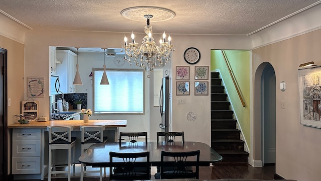 95 Mapleton Rd, Grosse Pointe Farms, MI 48236 - dining space featuring stairway, a textured ceiling, arched walkways, a chandelier, and dark wood-type flooring