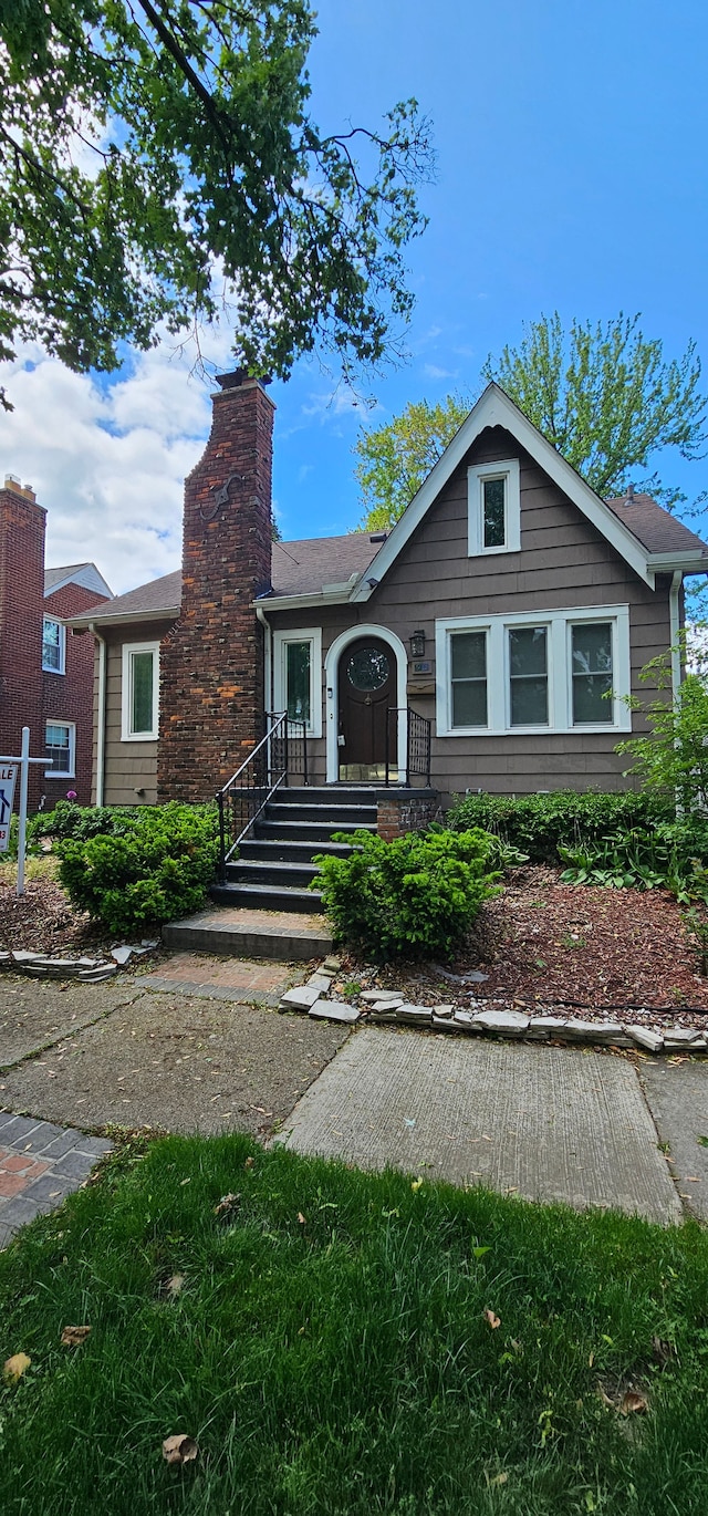 95 Mapleton Rd, Grosse Pointe Farms, MI 48236 - view of front of home featuring a chimney and roof with shingles