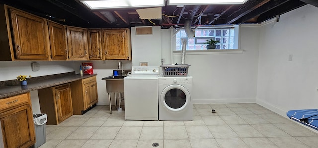 95 Mapleton Rd, Grosse Pointe Farms, MI 48236 - laundry area featuring washer and clothes dryer, cabinet space, light tile patterned floors, and baseboards