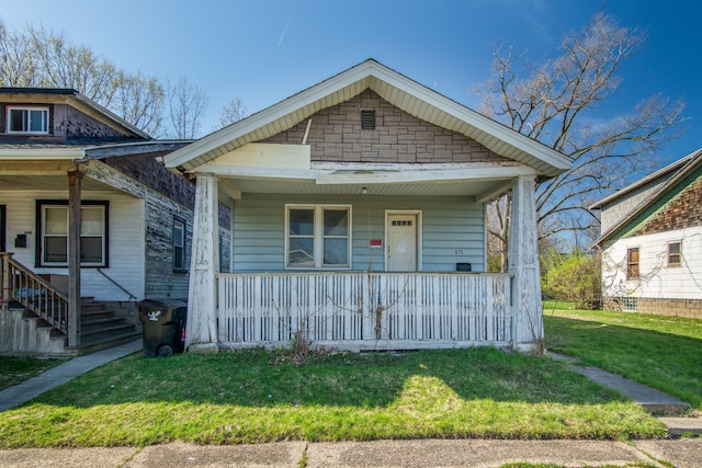 975 Fernhill St, Highland Park, MI 48203 - view of front of home featuring a porch and a front lawn