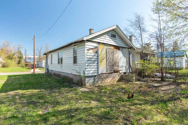 975 Fernhill St, Highland Park, MI 48203 - view of side of property with a chimney and a lawn