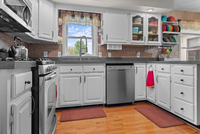 336 Jonesville Rd, Jonesville, MI 49250 - kitchen featuring stainless steel appliances, a sink, light wood-style flooring, and white cabinets