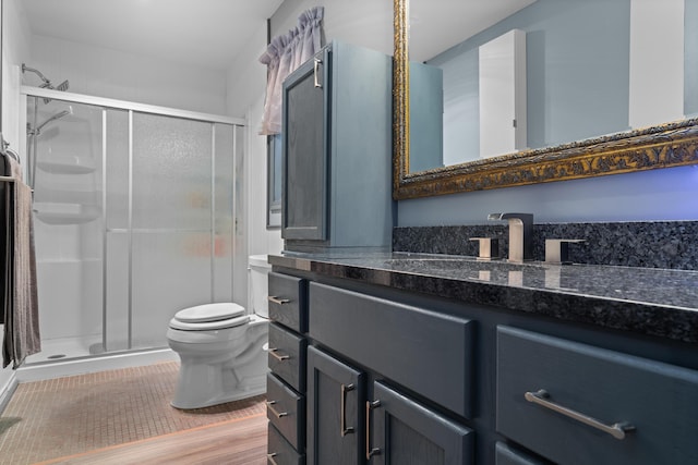 336 Jonesville Rd, Jonesville, MI 49250 - full bath featuring toilet, a stall shower, vanity, and wood finished floors
