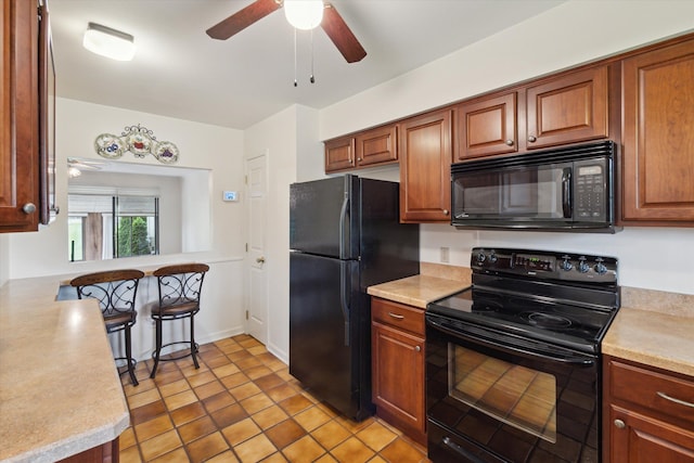 11928 Shenandoah Unit 3, South Lyon, MI 48178 - kitchen featuring black appliances, ceiling fan, light countertops, and brown cabinetry