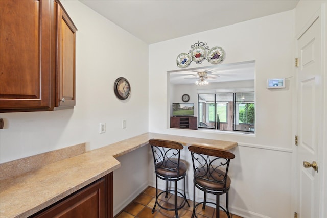 11928 Shenandoah Unit 3, South Lyon, MI 48178 - kitchen with light countertops, ceiling fan, and light tile patterned floors