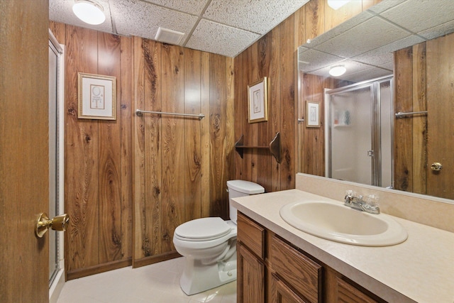 11928 Shenandoah Unit 3, South Lyon, MI 48178 - full bathroom with a drop ceiling, a stall shower, toilet, wooden walls, and vanity