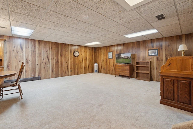 11928 Shenandoah Unit 3, South Lyon, MI 48178 - finished below grade area with light colored carpet, wooden walls, and a baseboard heating unit