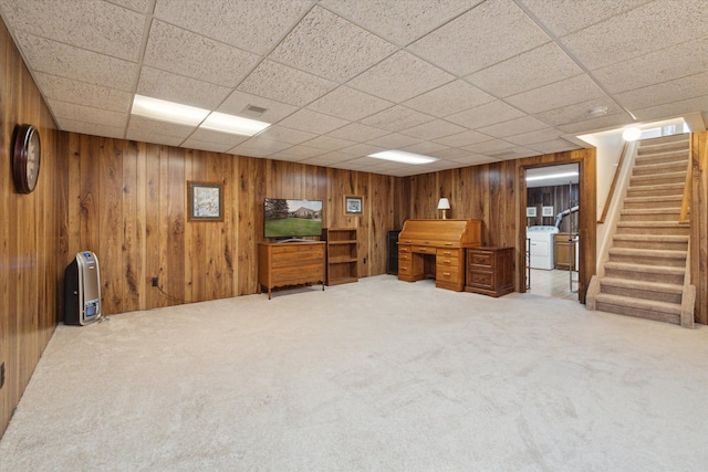 11928 Shenandoah Unit 3, South Lyon, MI 48178 - finished below grade area with carpet floors, stairs, wooden walls, a drop ceiling, and washer / clothes dryer
