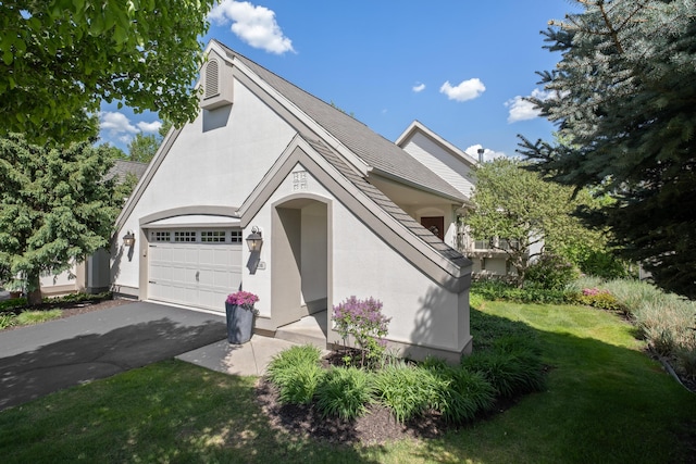416 Enclave Ct SE Unit 2, Grand Rapids, MI 49546 - view of front of property featuring driveway, a front yard, stucco siding, and a garage