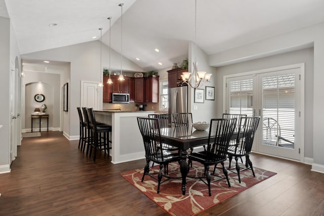 416 Enclave Ct SE Unit 2, Grand Rapids, MI 49546 - dining room with a chandelier, dark wood-style flooring, baseboards, arched walkways, and high vaulted ceiling