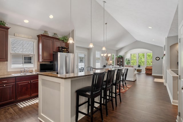 416 Enclave Ct SE Unit 2, Grand Rapids, MI 49546 - kitchen with freestanding refrigerator, a sink, vaulted ceiling, a kitchen island, and dark wood-style flooring
