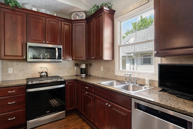 416 Enclave Ct SE Unit 2, Grand Rapids, MI 49546 - kitchen with appliances with stainless steel finishes, a sink, backsplash, dark wood-style floors, and dark brown cabinets