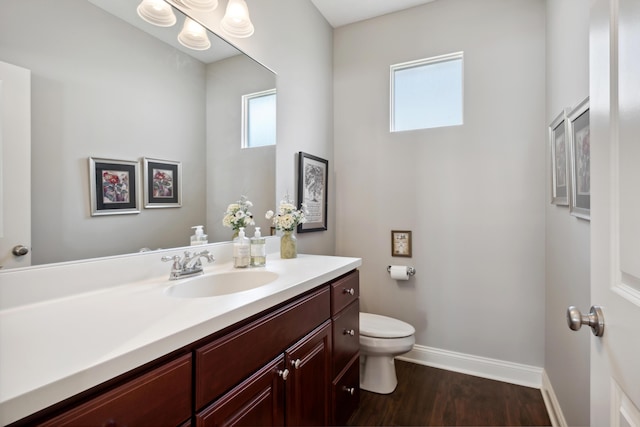 416 Enclave Ct SE Unit 2, Grand Rapids, MI 49546 - bathroom with toilet, wood finished floors, vanity, and baseboards