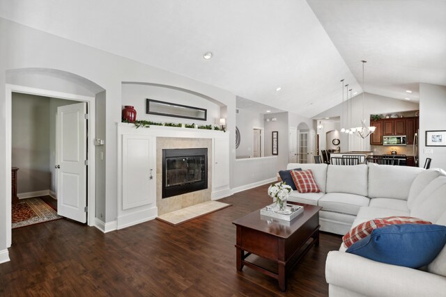 416 Enclave Ct SE Unit 2, Grand Rapids, MI 49546 - living room featuring vaulted ceiling, wood finished floors, baseboards, and a chandelier