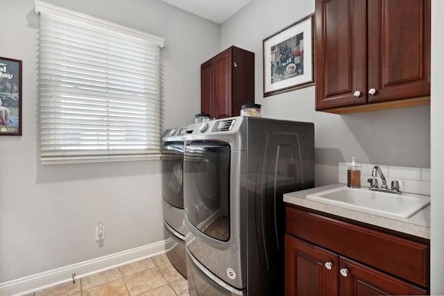 416 Enclave Ct SE Unit 2, Grand Rapids, MI 49546 - laundry room featuring washing machine and dryer, cabinet space, baseboards, and light tile patterned floors