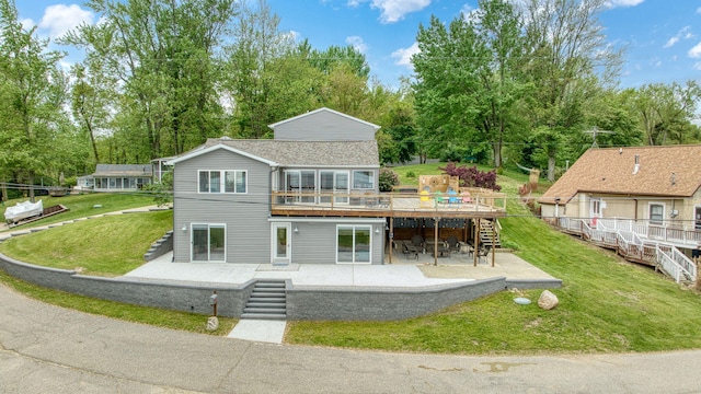 282 Evans Trl, Tipton, MI 49287 - back of property with a patio, stairway, a deck, and a yard